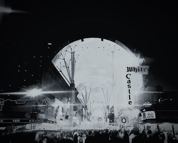 People in illuminated amusement park at night