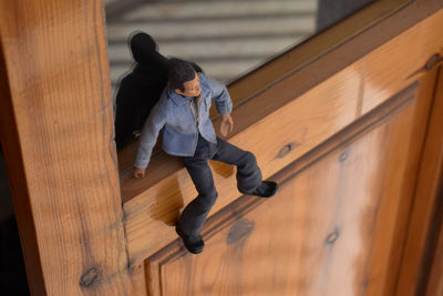 High angle view of child on wooden staircase