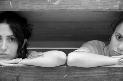 Portrait of woman sitting on floor at home