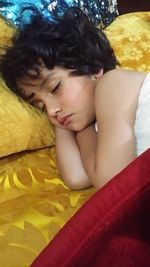 Portrait of boy sleeping on bed