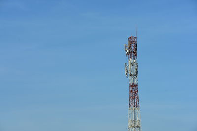 Communications tower against blue sky