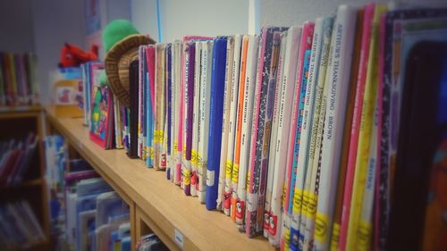 Multi colored books in shelf