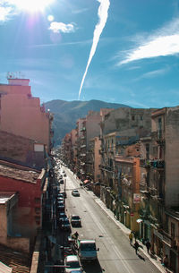 Panoramic view of city street and buildings against sky