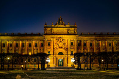 Illuminated building against sky at night