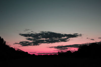 Silhouette trees against sky during sunset