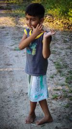 Full length portrait of cute boy standing outdoors