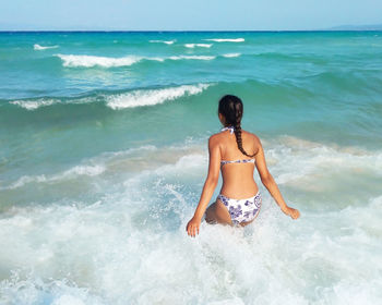 Rear view of woman on beach