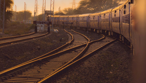 Railroad tracks amidst trees against sky