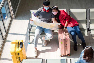 High angle view of couple sitting at airport