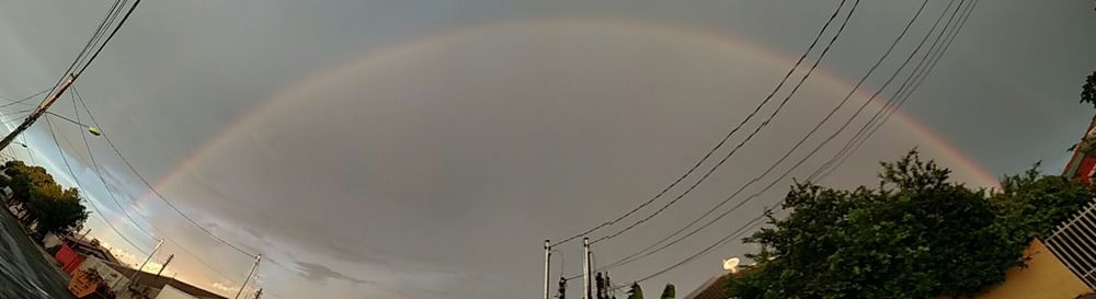 Low angle view of electricity pylon against sky