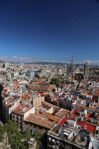 High angle shot of townscape against blue sky