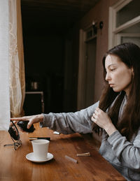 Young woman using mobile phone at home