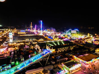 High angle view of illuminated city against clear sky at night