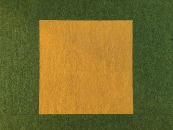 High angle view of paper against green background