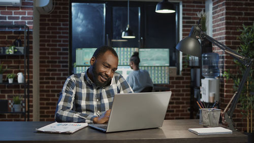 Businessman using laptop at table