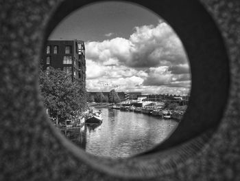 Reflection of buildings on river seen through window