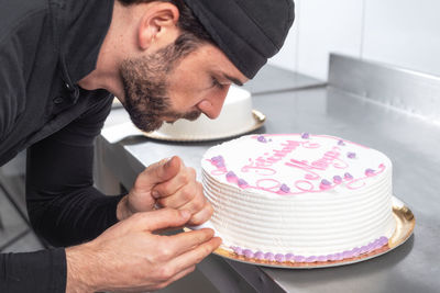 Midsection of man with chocolate cake