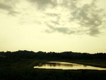 Scenic view of lake against sky during sunset