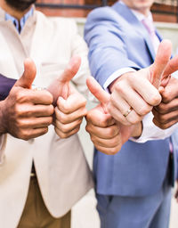 Midsection of couple holding hands