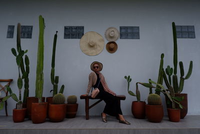Rear view of woman standing against wall