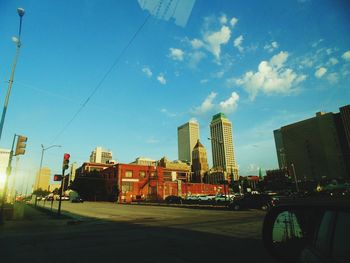 Buildings in city against blue sky