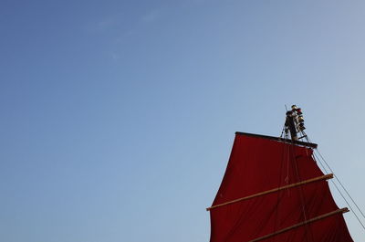 Low angle view of red boat against clear sky