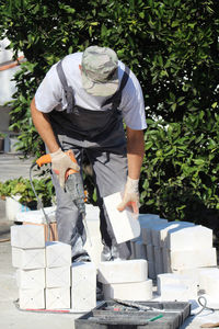 Man working on plant