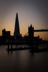 View of bridge over river at sunset