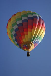 Low angle view of hot air balloon against blue sky