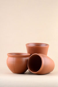 Close-up of tea cup on table against white background