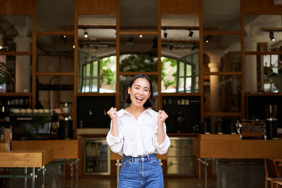 Portrait of woman standing in store