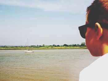 Portrait of man looking at sea against sky