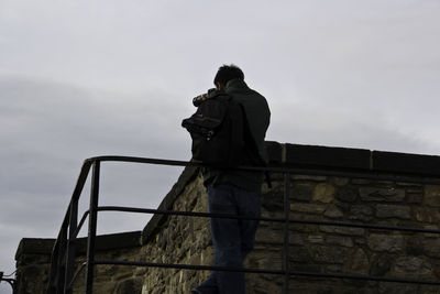 Low angle view of man standing against sky