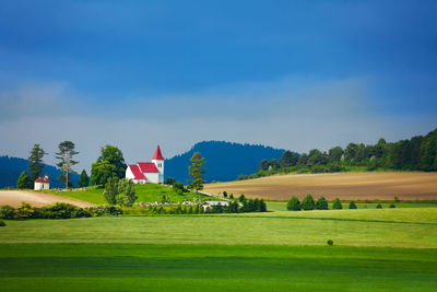 Scenic view of golf course against sky