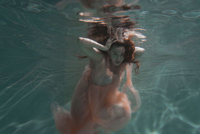 Woman swimming in swimming pool