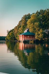 Gazebo by lake against clear sky