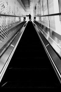 Rear view of man on escalator