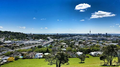 Scenic view of cityscape against blue sky