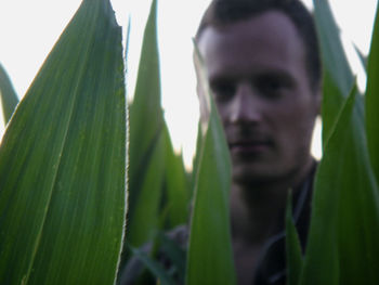 Close-up portrait of young man amidst leaves