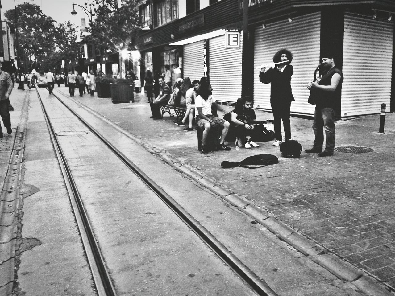 GROUP OF PEOPLE STANDING ON TILED FLOOR