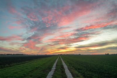 Scenic view of field against sky during sunset