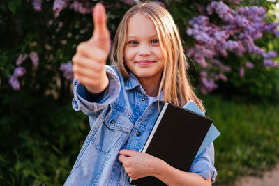 Portrait of young woman using digital tablet