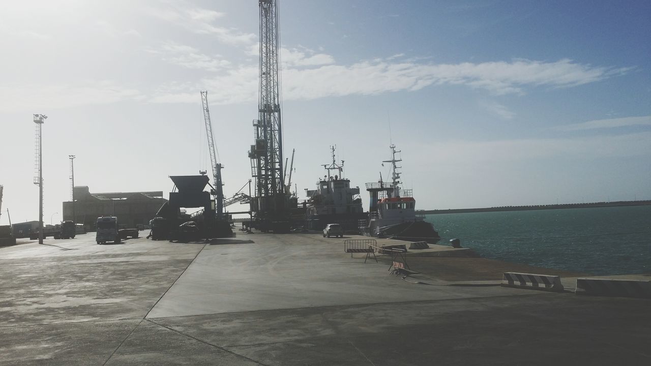 VIEW OF COMMERCIAL DOCK AGAINST SKY