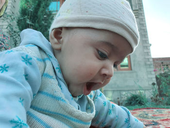 Close-up portrait of cute boy wearing hat