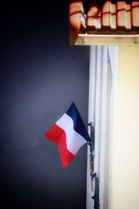 Close-up of flag against blue wall