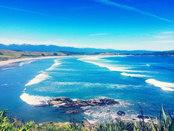 Scenic view of sea against blue sky