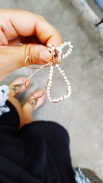 Directly above view of woman holding jewelry