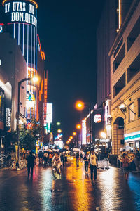 People walking on road in city at night