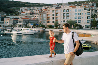 Portrait of smiling young woman standing in city