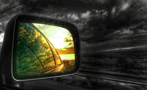 Reflection of car on road at sunset